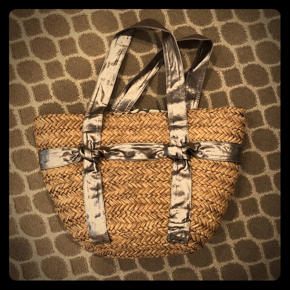 Straw beach bag. Goldish silver straps.